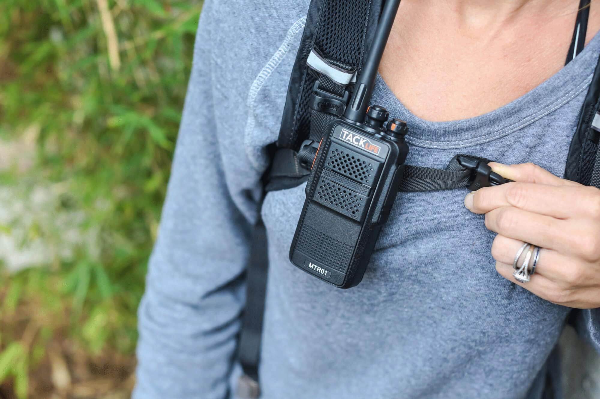 walkie talkie clipped to backpack strap