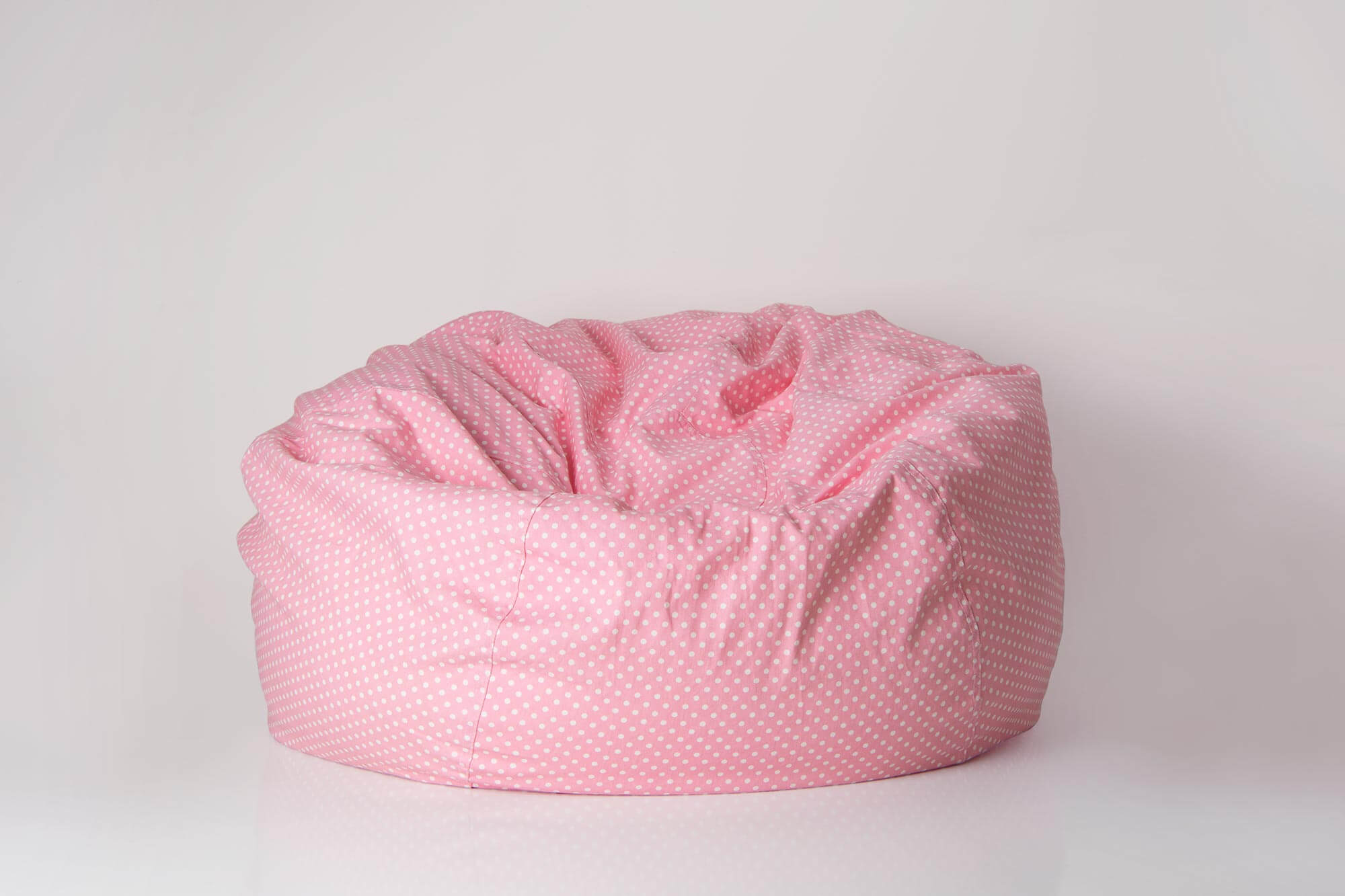 Pink Flash Furniture bean bag on floor