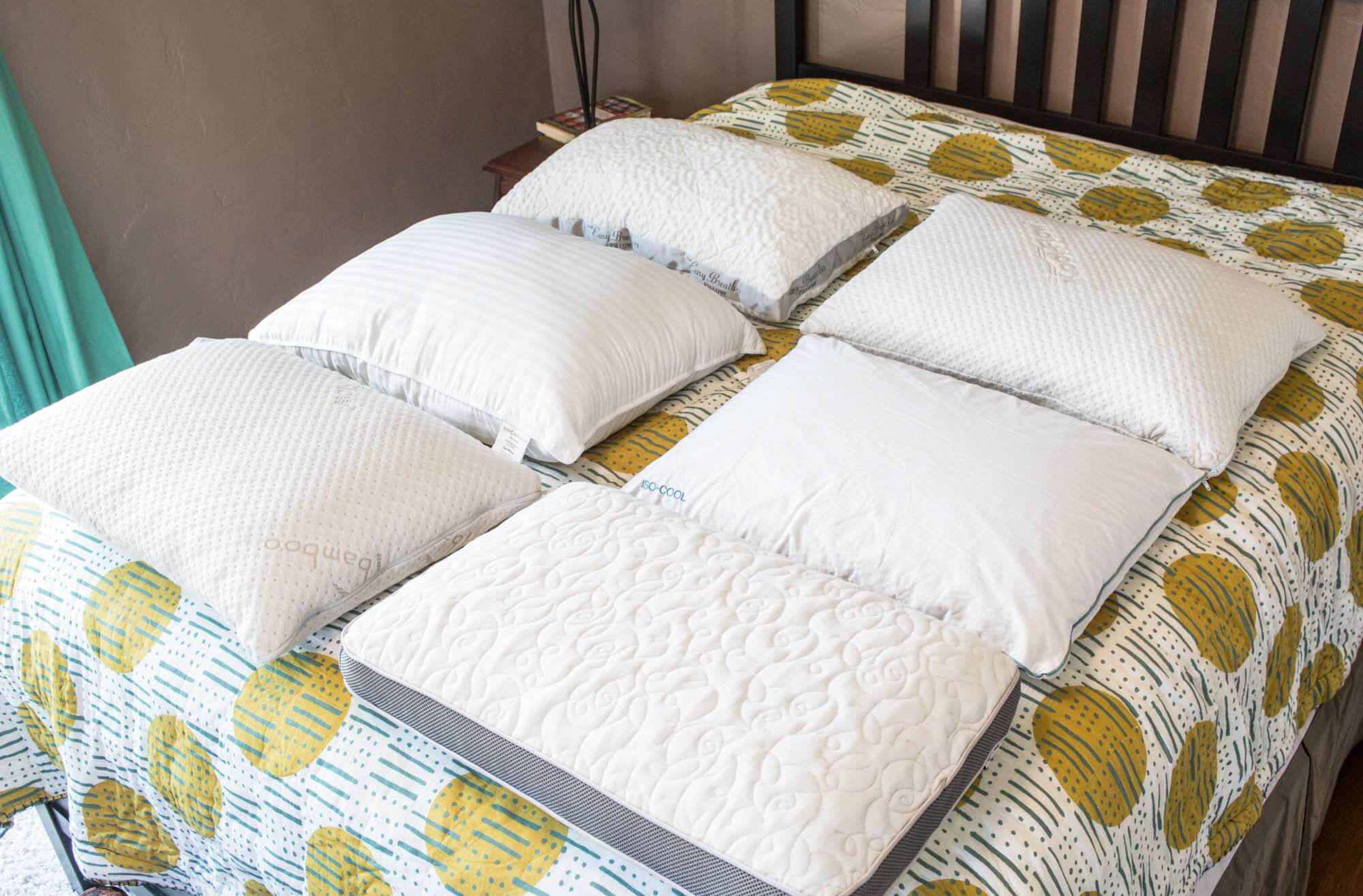 group shot of six best cooling pillows on a bed