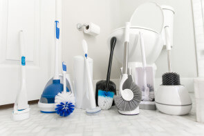 group of toilet brushes in bathroom
