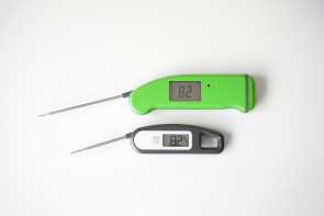 two digital thermometers on a table
