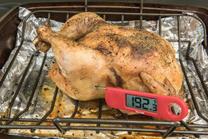 food thermometer in a roasted chicken