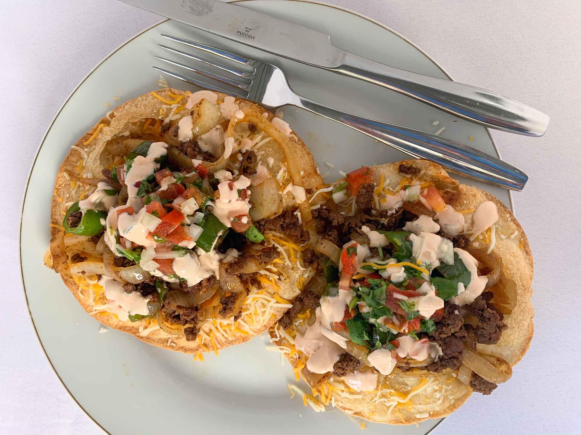 two cheesy beef tostadas