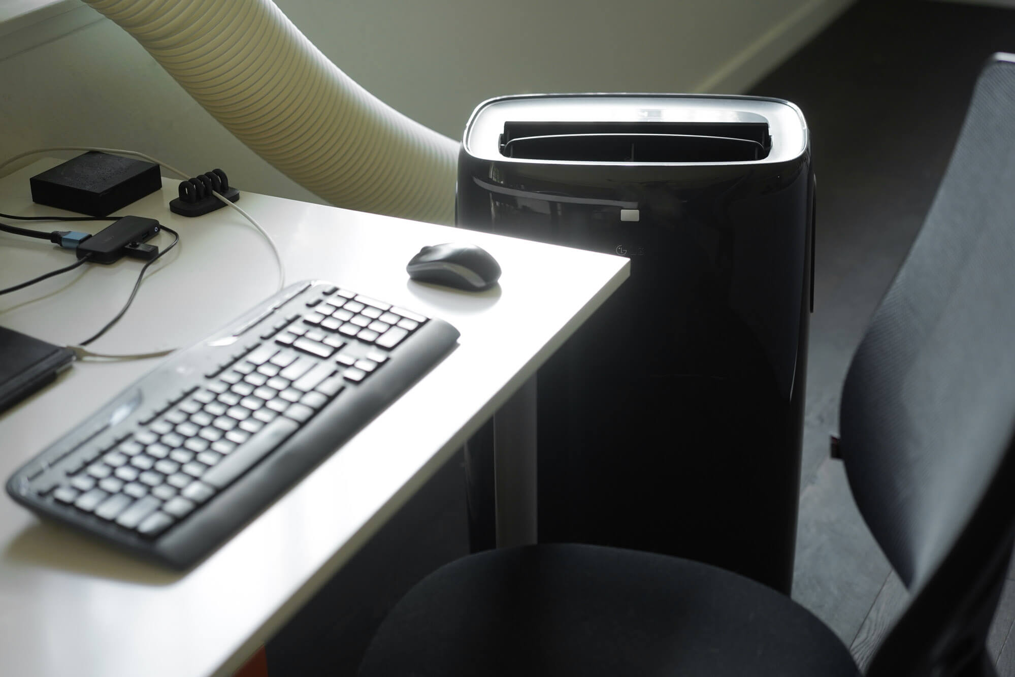 portable AC next to a workdesk