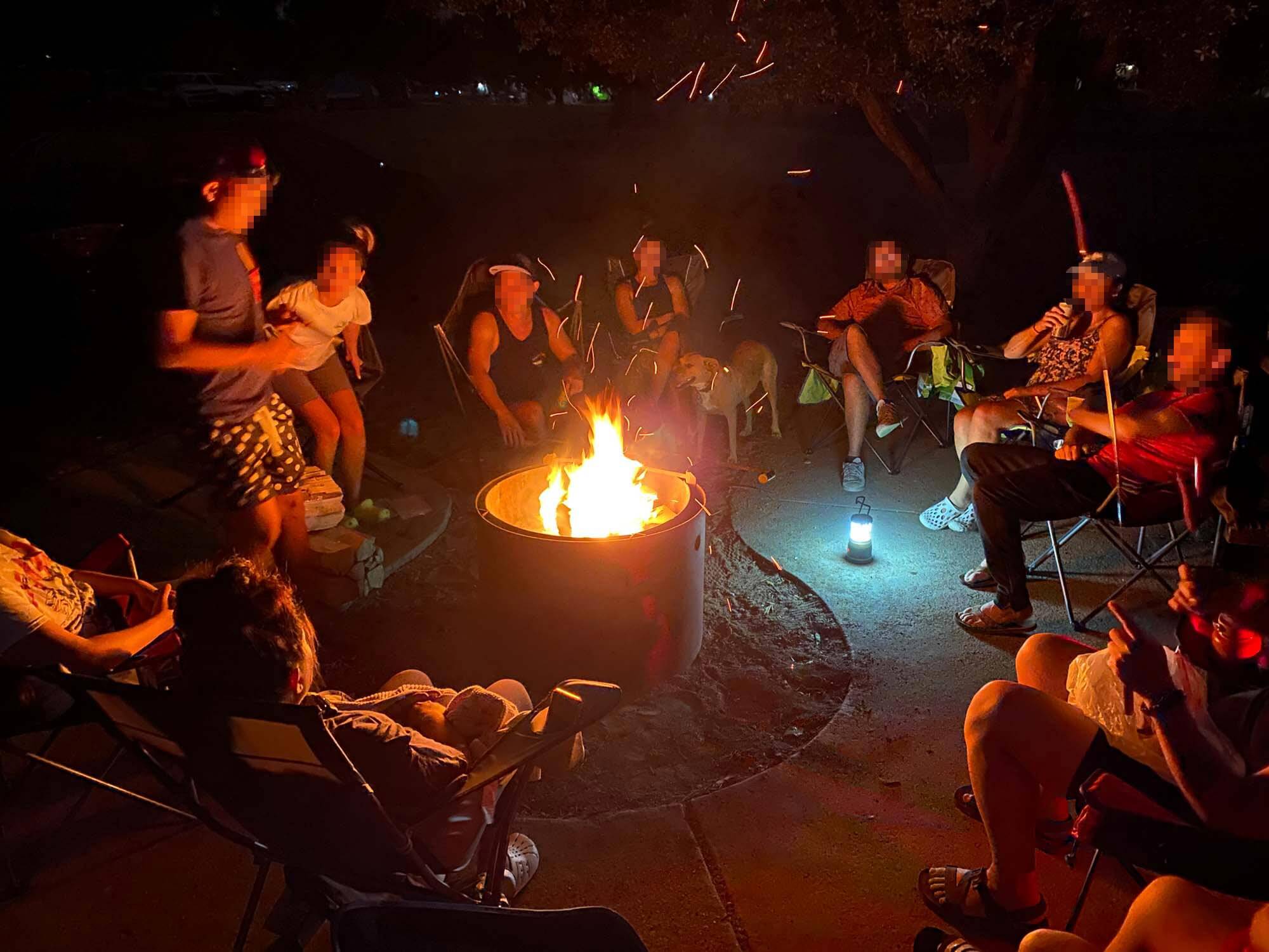 group hanging out by a campfire