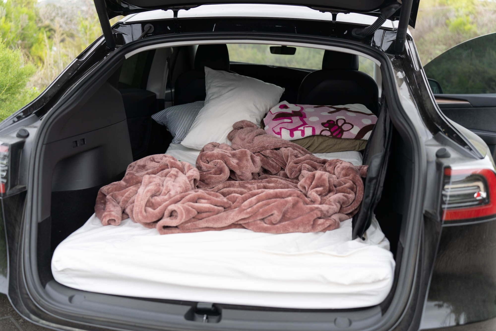 Model Y trunk camping mattress, blankets, pillows