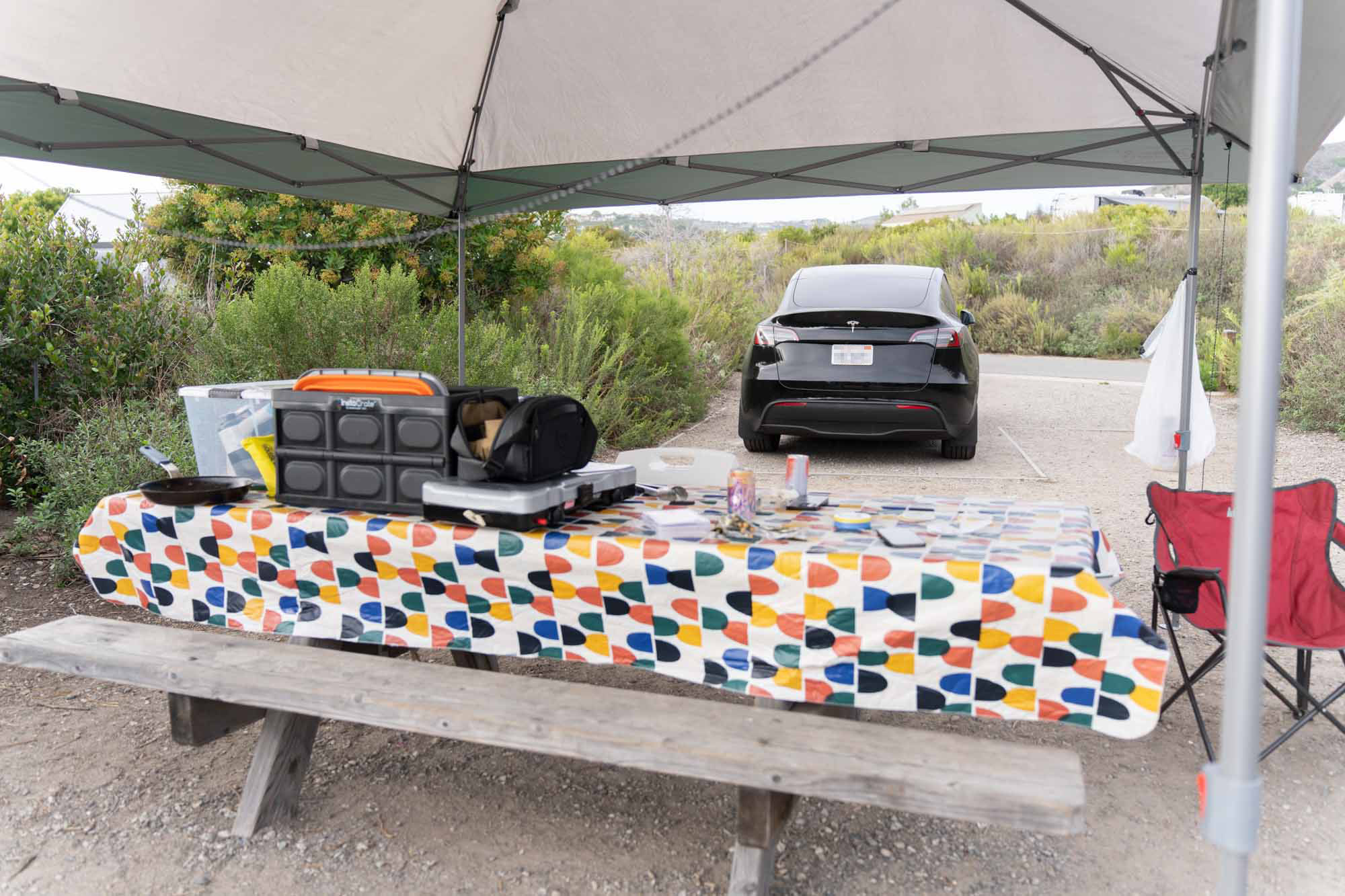 Tesla Model Y next to campsite table